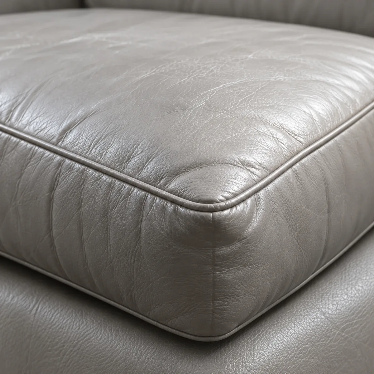 Close-up of a grey leather seat cushion edge