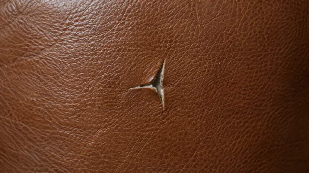 Small tears, leather loveseat detail