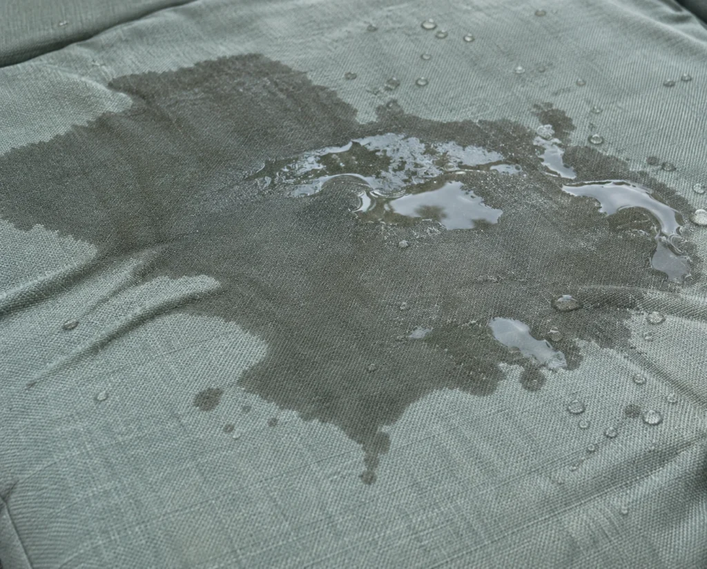 Puddle of rainwater sitting on an outdoor cushion cover